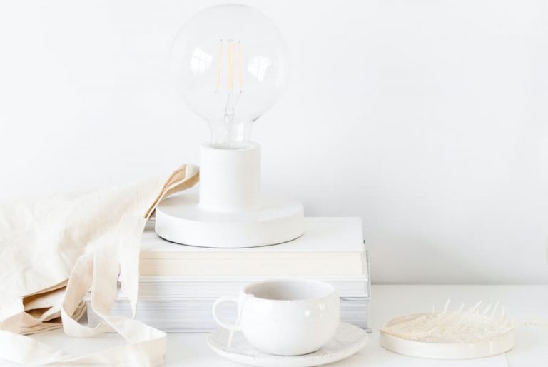 minimalist workspace with coffee and lightbulb.