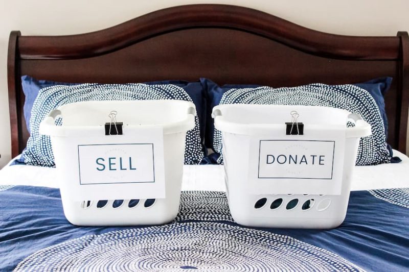 laundry baskets on a bed labeled"sell" and"donate".