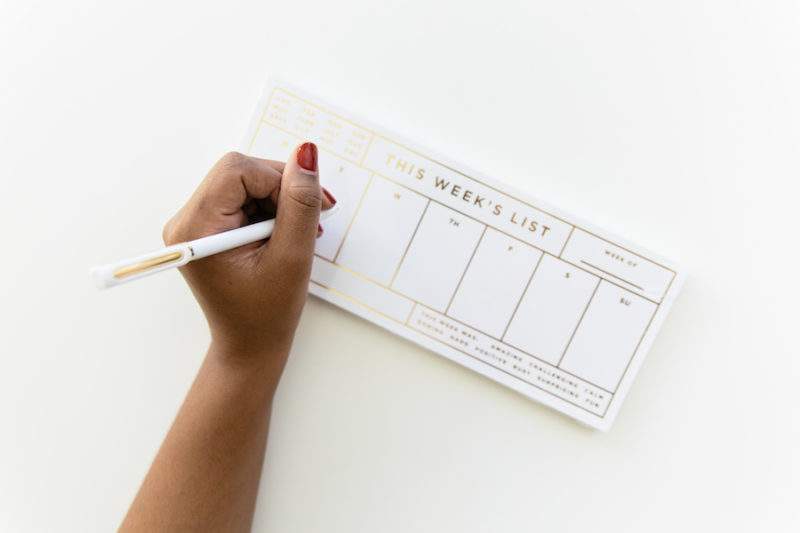 woman writing a To Do list.