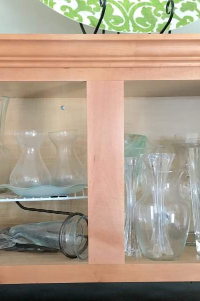 kitchen cabinet full of vases.