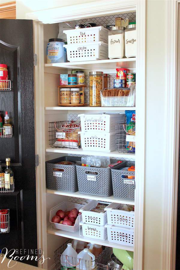 looking inside an organized reach in pantry after a makeover.