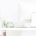 clutter-free white desk with white computer monitor - text overlay "organize your email: how to achieve inbox zero".
