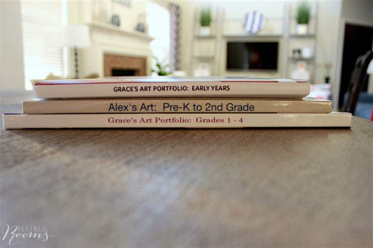 stack of digital photo books to organize kids artwork.