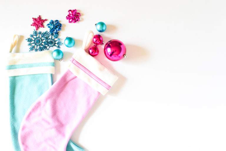 pink and blue stockings with christmas ornaments.