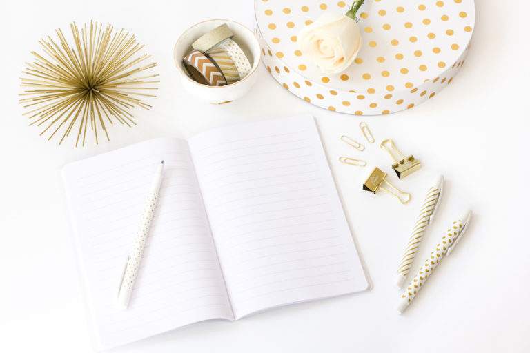 office desktop with pretty office supplies and a blank notebook.
