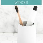 bathroom organization products - toothbrush and toothpaste in a cup on bathroom counter