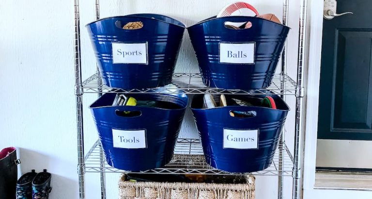 labeled bins on garage shelf.