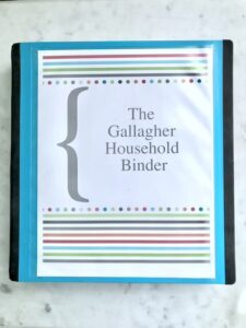 binder on countertop with cover that reads "The Gallagher Household Binder".