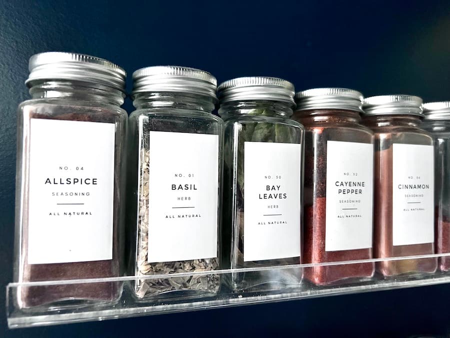 Convenient Spice Drawer Organization with Glass Jars and Labels