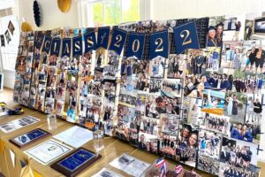 large photo collage displayed on a table at a high school graduation party.