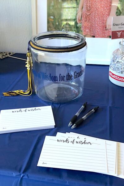 Words of Wisdom table display (jar and cards for guests to write on) at a high school graduation party.