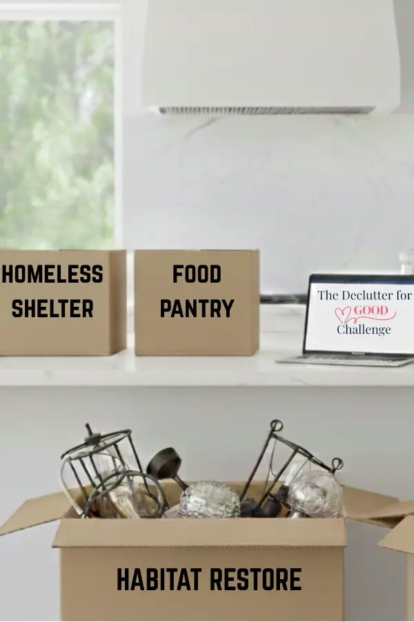 white kitchen filled with boxes of decluttered items.
